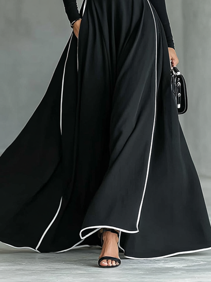 Elisa | Vestido maxi negro con costuras blancas y cuello alto